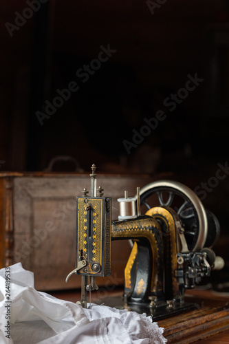 Process of sewing on the ancient sewing machine in the antiquarian case. Soft focus. 