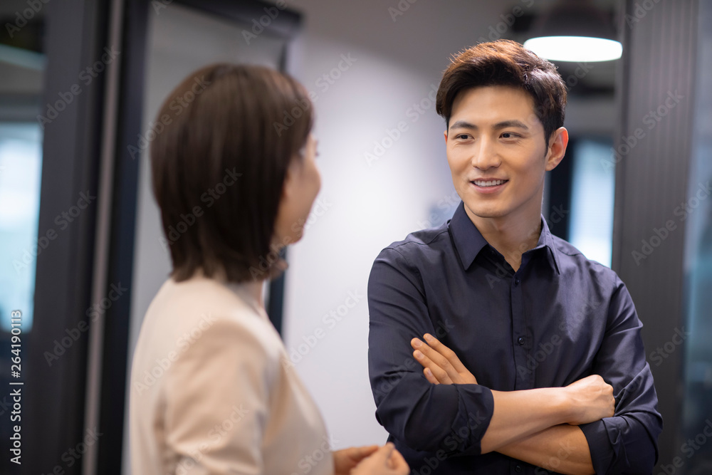 Young businesswoman and businessman talking in corridor Young businesswoman and businessman talking in corridor