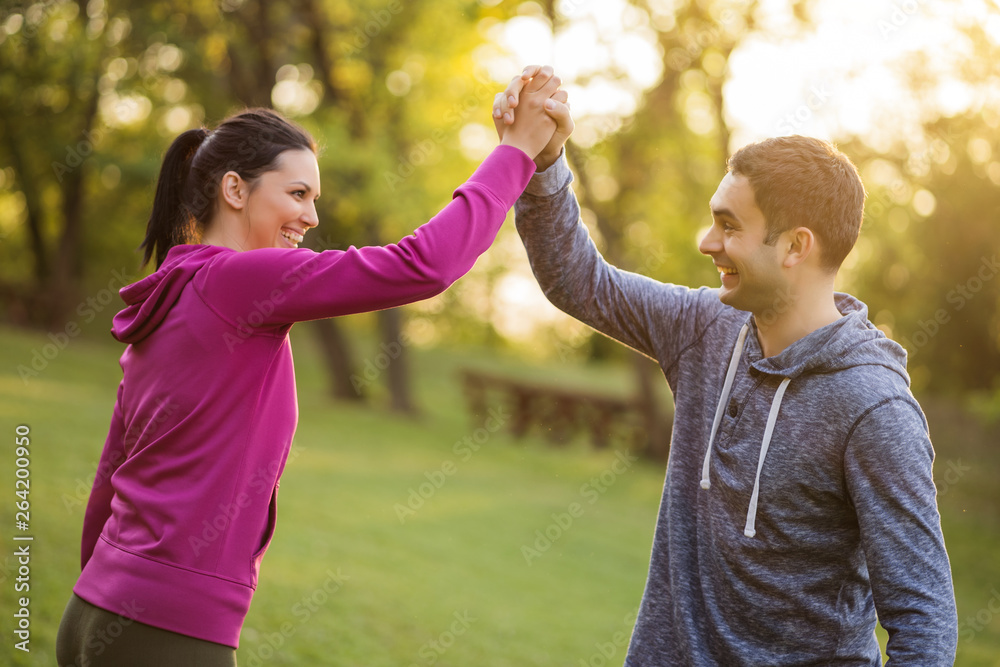 Fototapeta premium Young couple is happy after exercising in park.