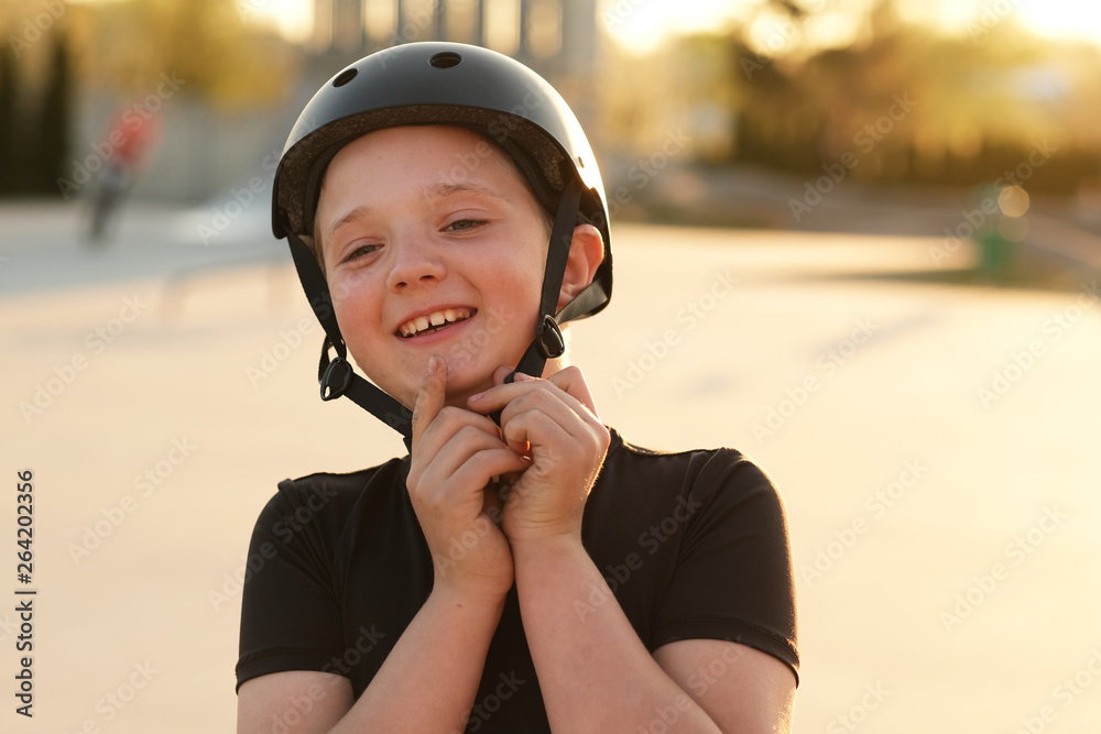 Safety first! Young boy closing his helmet Safety first! Young boy closing his helmet