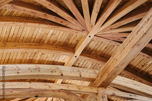 Part of the wooden architecture of the building interior. The wood-paneled ceiling with wooden beams lining. Everywhere is present texture of wood with knots and its own specific structure.