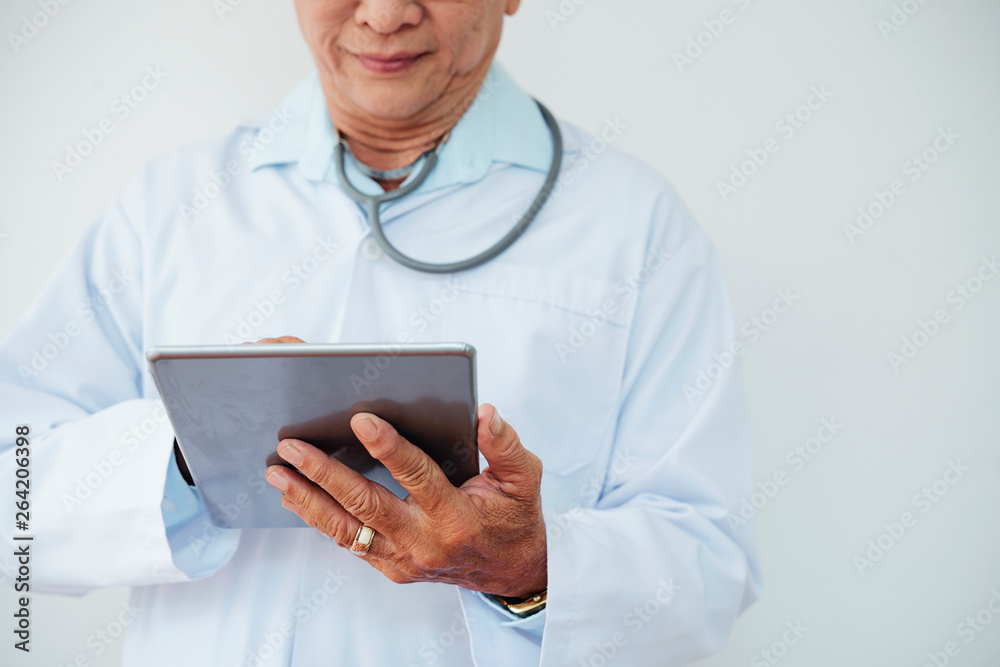 Doctor working on tablet computer Doctor working on tablet computer