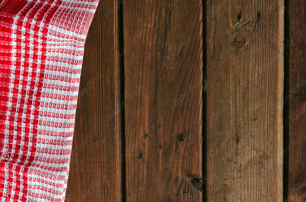 Red checkered picnic cloth on brown wooden table. Red checkered picnic cloth on brown wooden table.