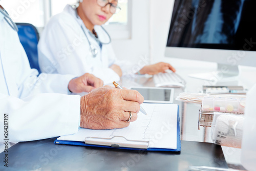 Cardiologist checking patients test results