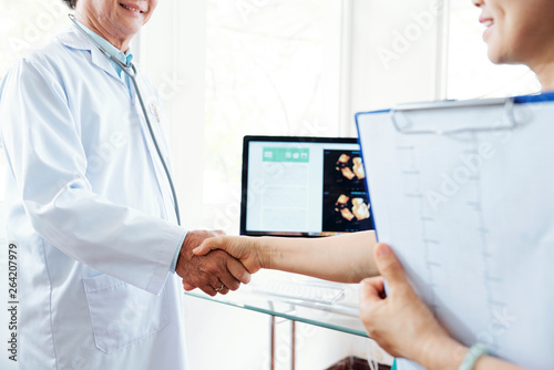 Doctor shaking hand of cardiologist photo