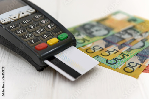 Australian dollar banknotes with terminal and credit card