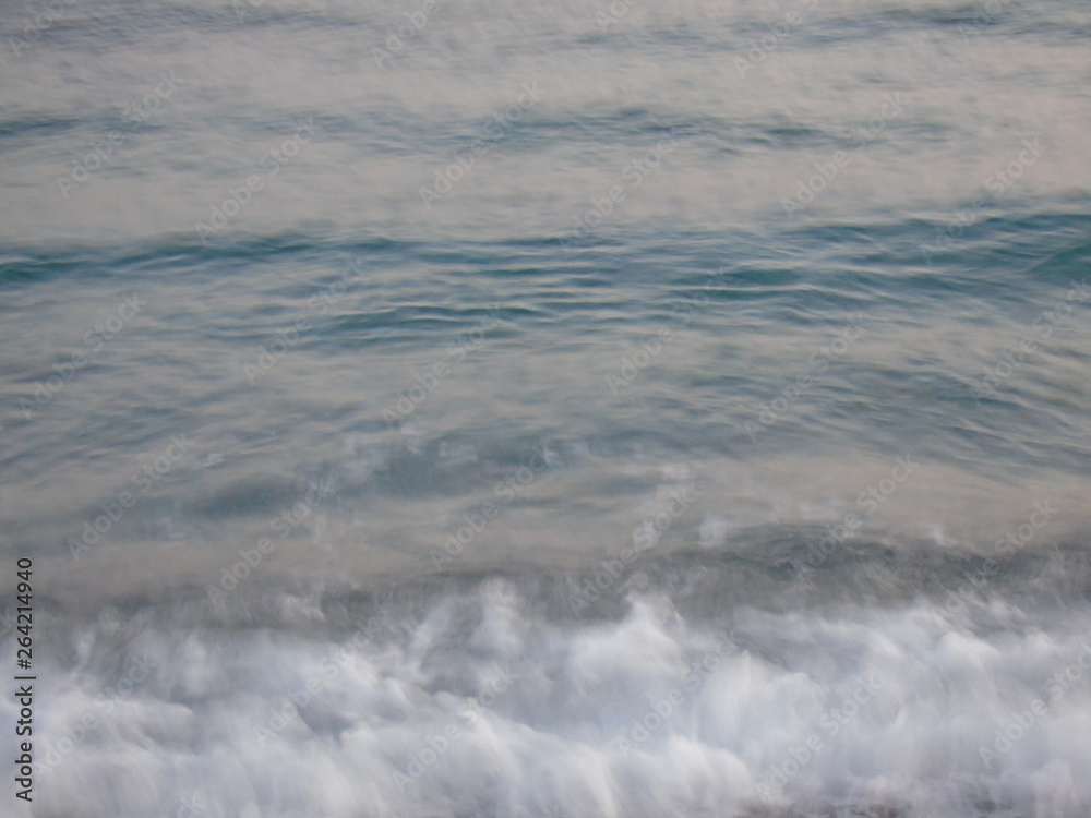 Genova, Italy - 04/22/2019: Close-up of big waves breaking on the coast in Liguria, Italy, Europe. White waves of the sea break on the cliff. Genova, Italy - 04/22/2019: Close-up of big waves breaking on the coast in Liguria, Italy, Europe. White waves of the sea break on the cliff.