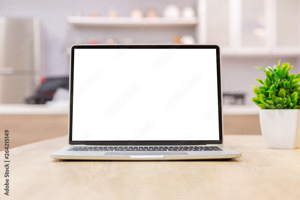 Fototapeta premium laptop showing blank screen on work table front view in home- Image