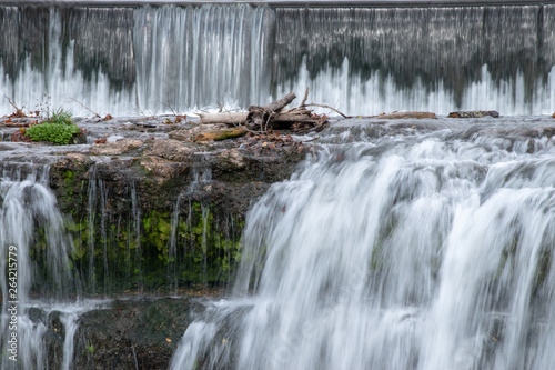 With a slow shutter speed the waters appear milky as it flows over the ledge at the Falls in Joplin  MO