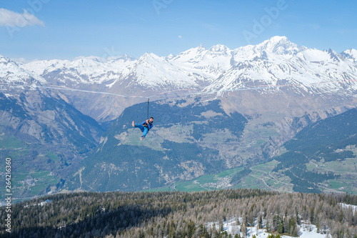 a man hanging on a highline in the French Alps, Auvergne-Rhône-Alpes, Bourg-Saint-Maurice, France © Fred Marie