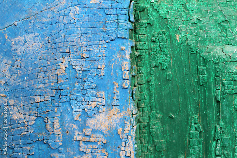 Obraz premium Old wooden background with remains of pieces of scraps of old paint on wood. Texture of an old tree, vintage wood background peeling paint. old blue board with cracked paint