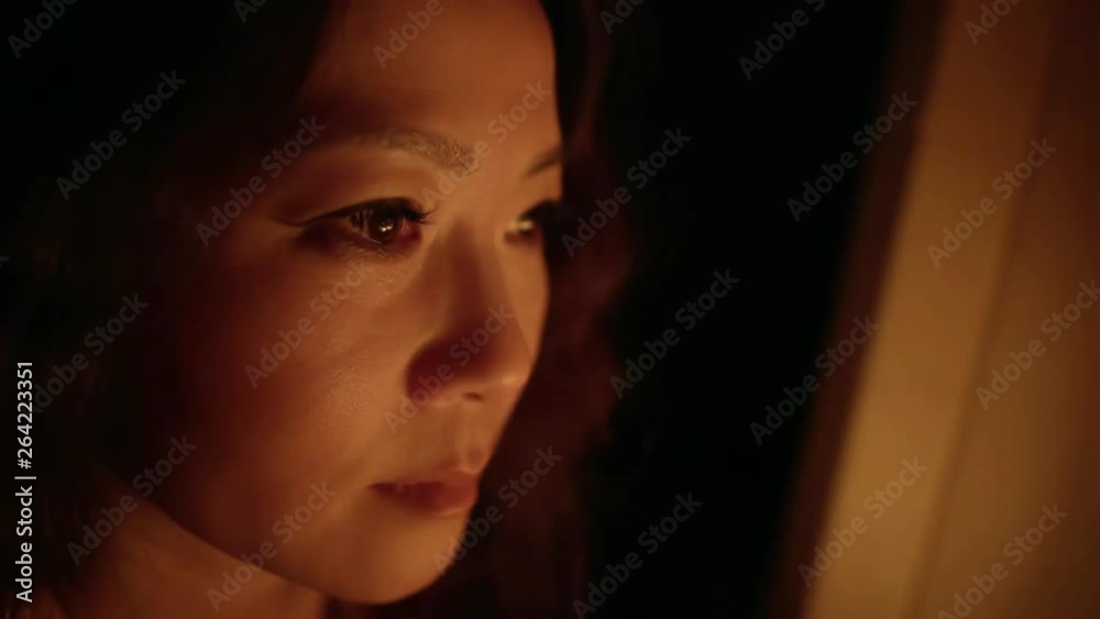 Asian Japanese girl portrait red light from fire near Asian Japanese girl portrait red light from fire near