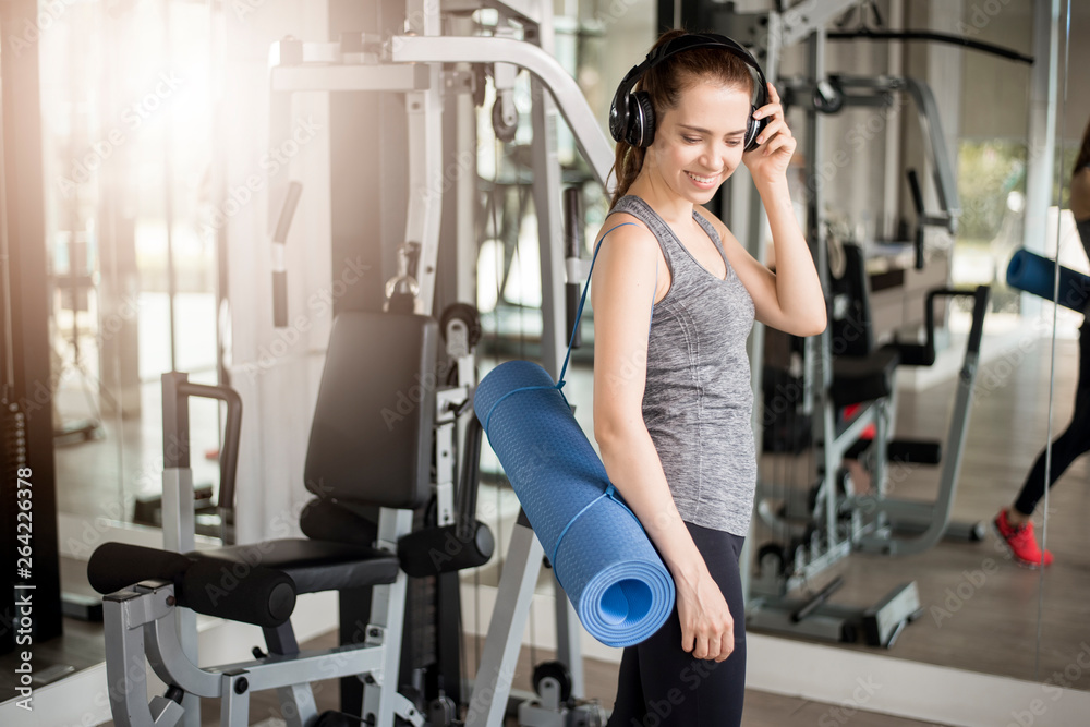 Pretty young sport woman is workout with mat in gym, Healthy lifestyle Pretty young sport woman is workout with mat in gym, Healthy lifestyle
