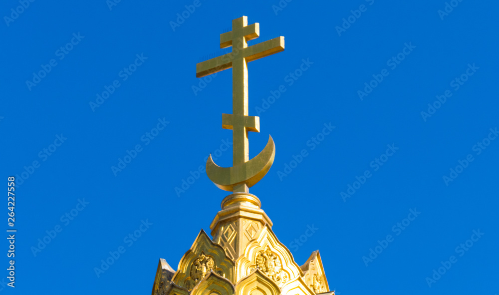 Gilded cross on a monument Gilded cross on a monument