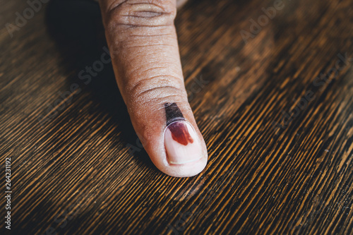 Closeup Shot of the finger of the Indian man marked with ink showing depicting that he gave his vote