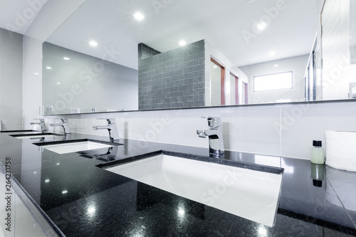 public Interior of bathroom with sink basin faucet lined up Modern design.