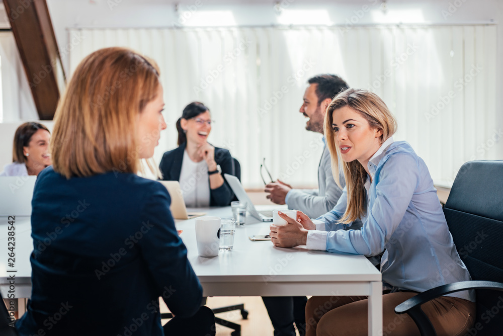 Business people discussing ideas at meeting.