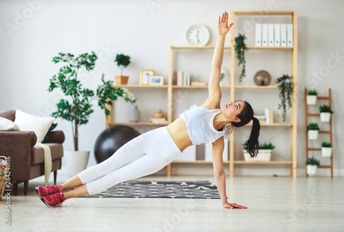 young woman doing fitness and sports at home    .