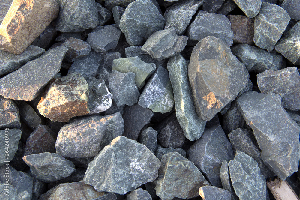 mound of small and large crushed stones with golden light rays mound of small and large crushed stones with golden light rays