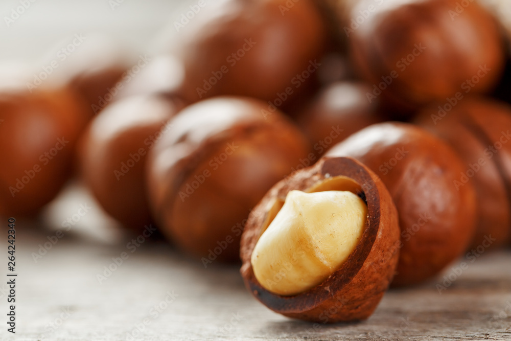 Macadamia nut on a wooden table in a bag, closeup, top view Macadamia nut on a wooden table in a bag, closeup, top view