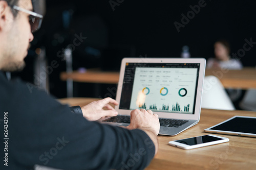 Closeup of man working on laptop with finances or ceo, graph, business analytics and strategy
