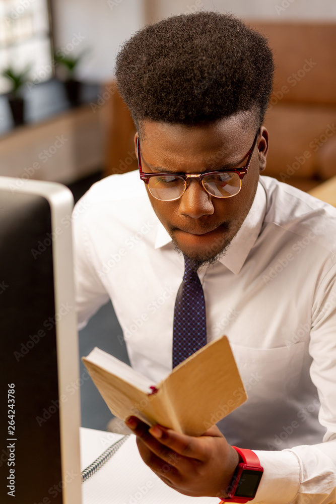 Serious nice young man studying his notes Serious nice young man studying his notes