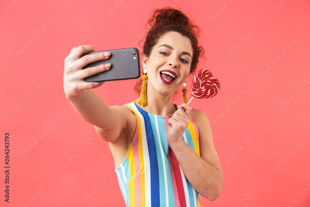 Smiling pretty redhead woman wearing in dress making selfie Smiling pretty redhead woman wearing in dress making selfie