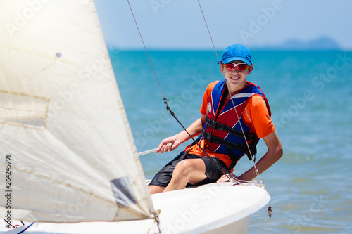 Man sailing. Boy learning to sail on sea yacht. © famveldman