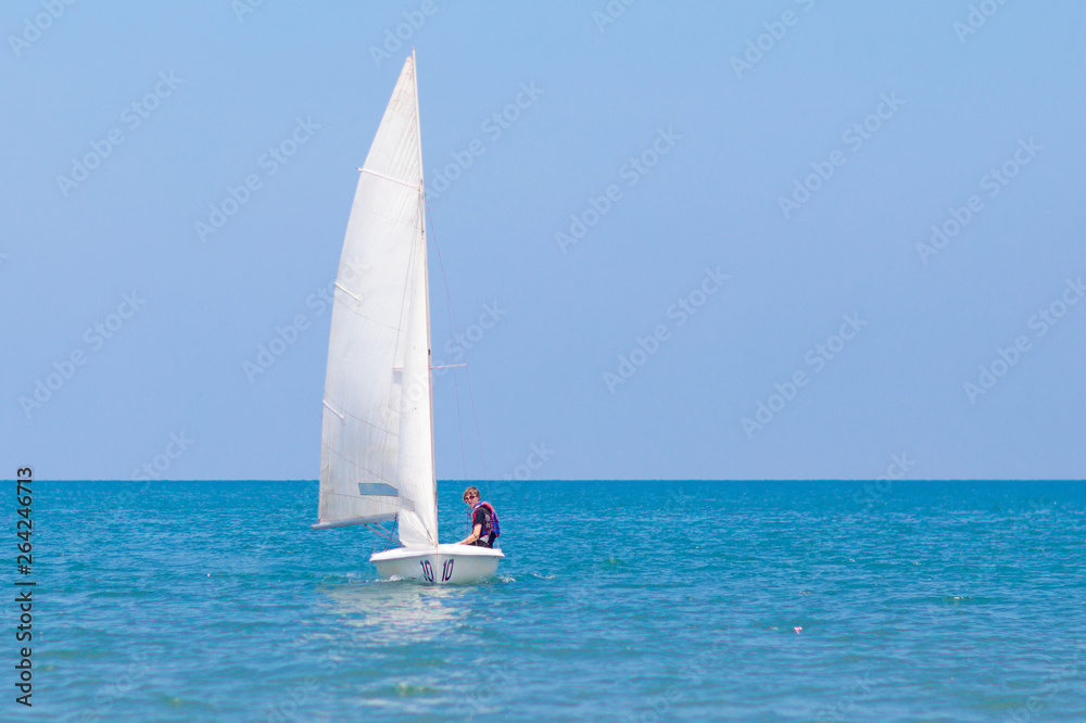 Obraz premium Man sailing. Boy learning to sail on sea yacht.