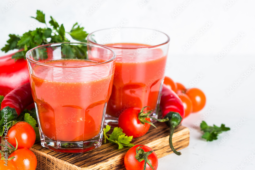 Tomato vegetable juice in glass on white. Tomato vegetable juice in glass on white.