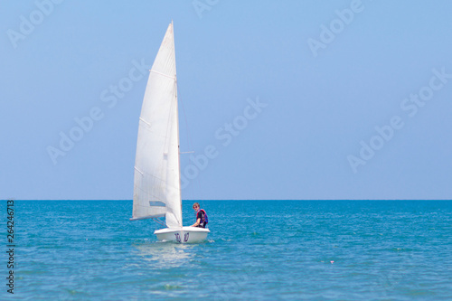 Man sailing. Boy learning to sail on sea yacht.