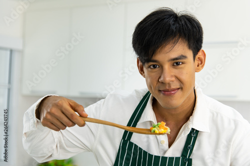 Chef cooking fried rice in kitchen