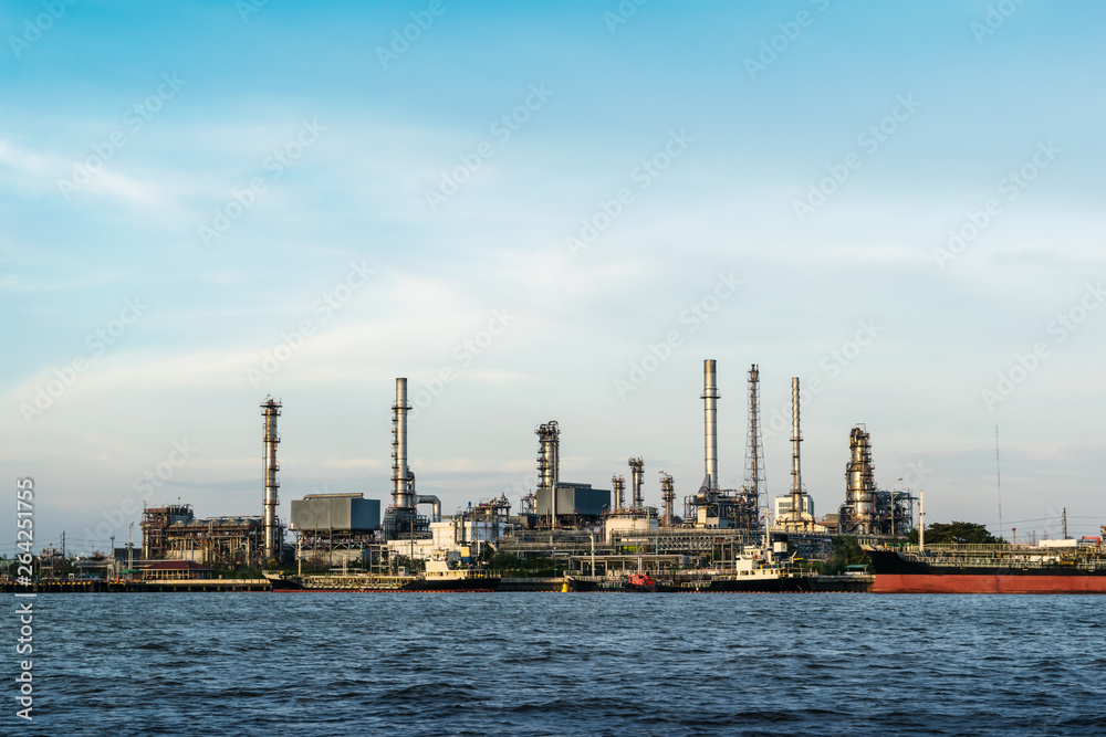 The oil refinery is located by the river