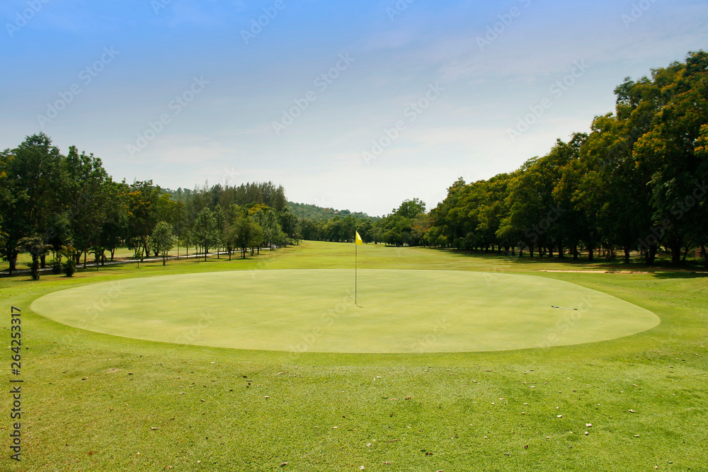 The evening golf course has sunlight shining down at golf course in Thailand