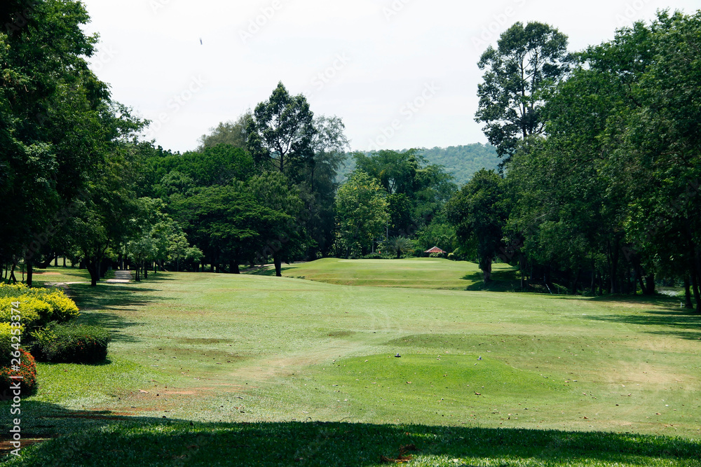 The evening golf course has sunlight shining down at golf course in Thailand The evening golf course has sunlight shining down at golf course in Thailand