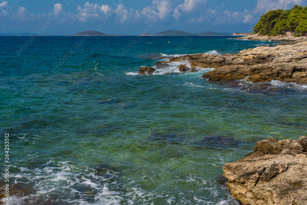 Waves breaking on a stony beach in Murter, Croatia, Dalmatia Waves breaking on a stony beach in Murter, Croatia, Dalmatia