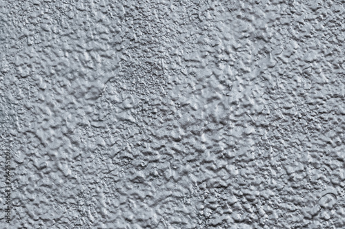 Abstract raggy silver background. The pattern of gray shiny cement wall. Reflecting uneven texture with metallic gloss. Reflective surface of foil. Shiny gray wall background. The grey shiny plaster
