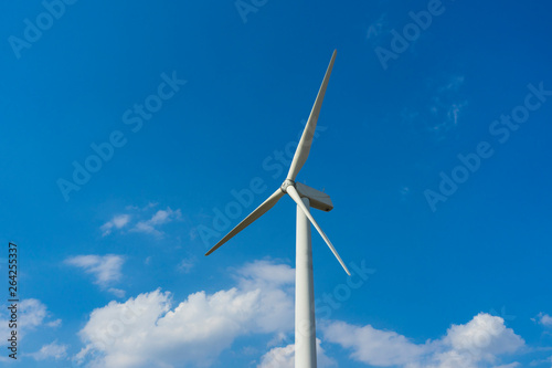 wind turbine against blue sky. © bennnn
