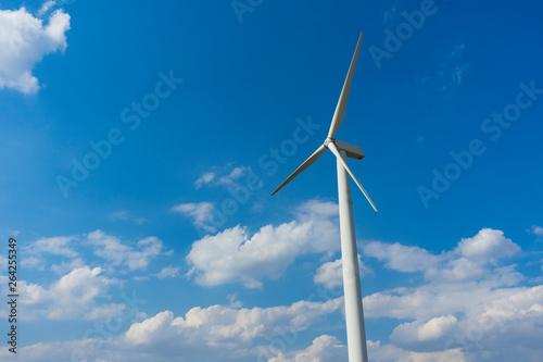 wind turbine against blue sky. © bennnn