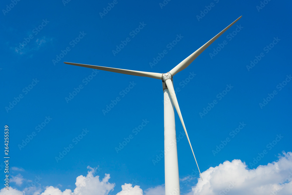 wind turbine against blue sky.