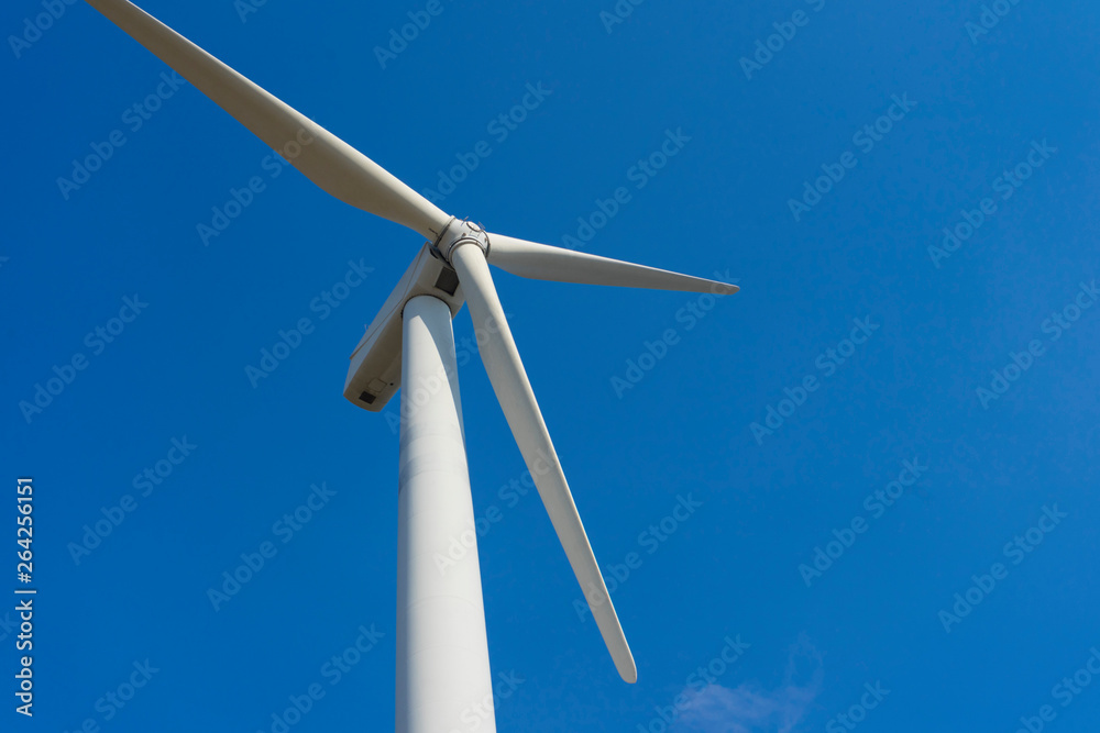 wind turbine against blue sky.