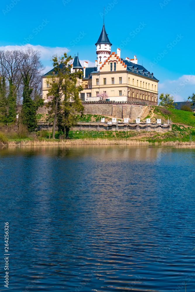Renaissance old castle Radun near Opava city mirrored in a lake with reflections in water, Czech Republic