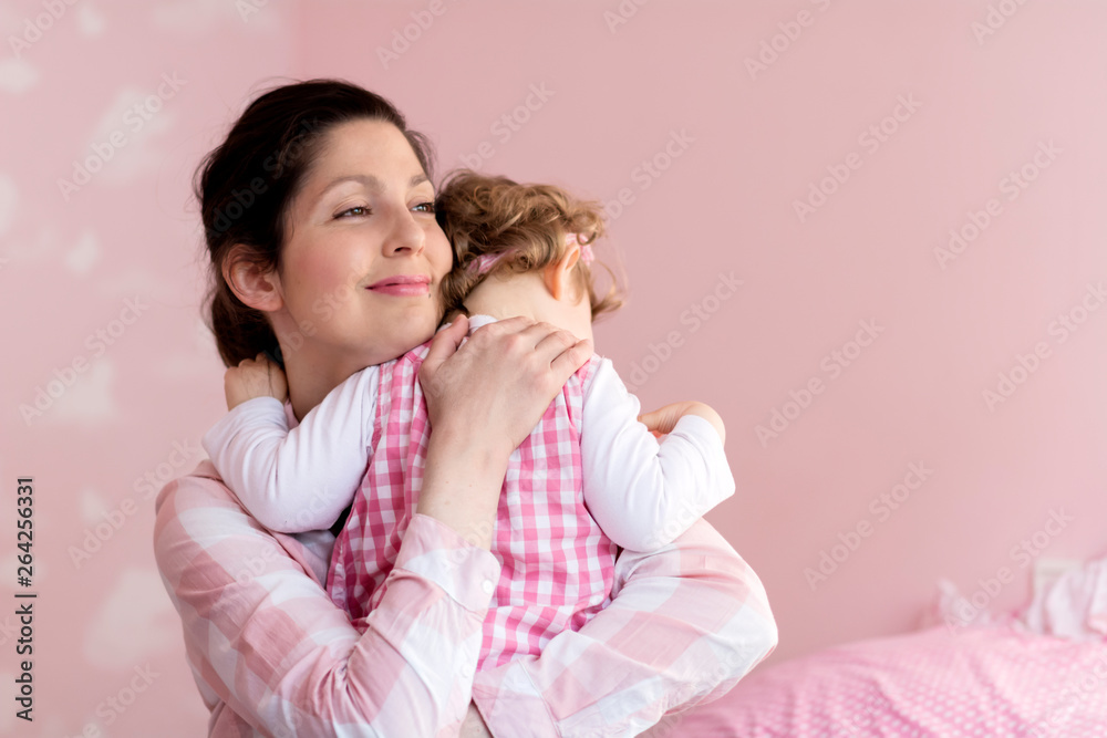 Happy Mother with her Baby Girl Hugging at Home .Mother and Daughter .Happy Family, Mother with Little Child Happy Mother with her Baby Girl Hugging at Home .Mother and Daughter .Happy Family, Mother with Little Child