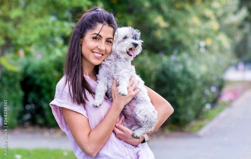 Beautiful Smiling Woman Hugging Her Cute Havanese Dog .Pet and Owner Outdoor Beautiful Smiling Woman Hugging Her Cute Havanese Dog .Pet and Owner Outdoor