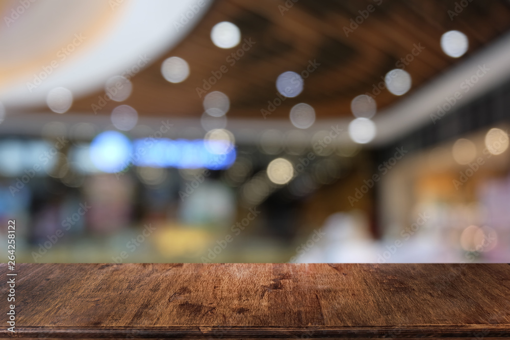 Empty dark wooden table in front of abstract blurred bokeh background of restaurant . can be used for display or montage your products.Mock up for space.