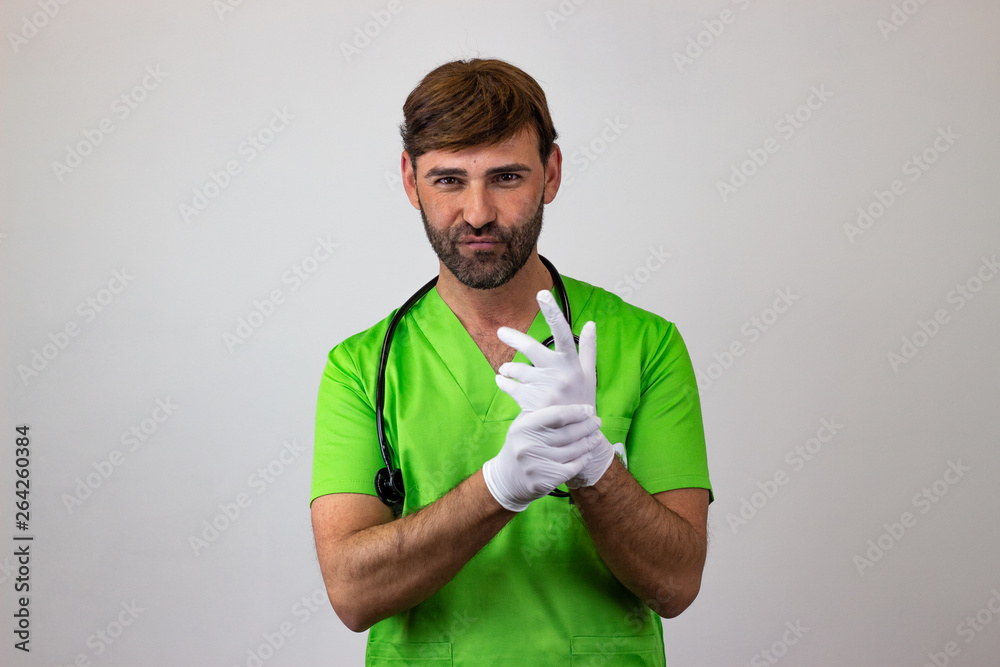 Portrait of male veterinary doctor in green uniform with brown hair showing confidence, looking at the camera. Isolated on white background. Portrait of male veterinary doctor in green uniform with brown hair showing confidence, looking at the camera. Isolated on white background.