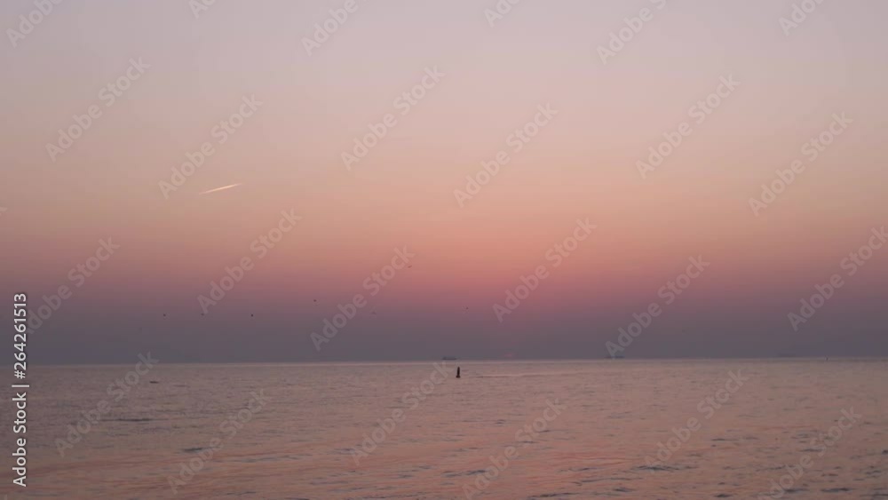 Pink sunset and a last second of visible red sun in the horizon Pink sunset and a last second of visible red sun in the horizon