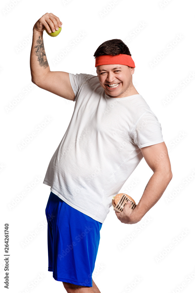 Obraz premium concept man makes the choice between healthy and unhealthy food. the choice between a burger and an apple. will power when dieting.