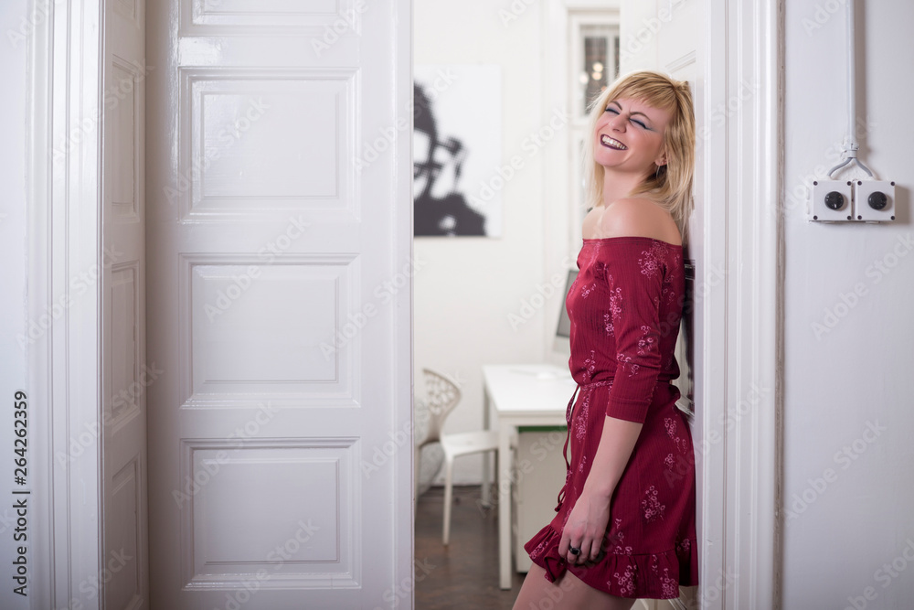 Beautiful young blonde woman wearing red dress smiling Beautiful young blonde woman wearing red dress smiling