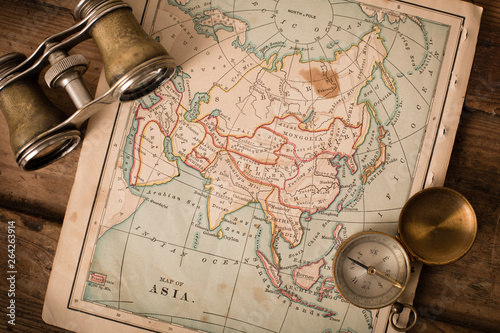 Binoculars and Compass on 1870 Map of Asia – World Travel